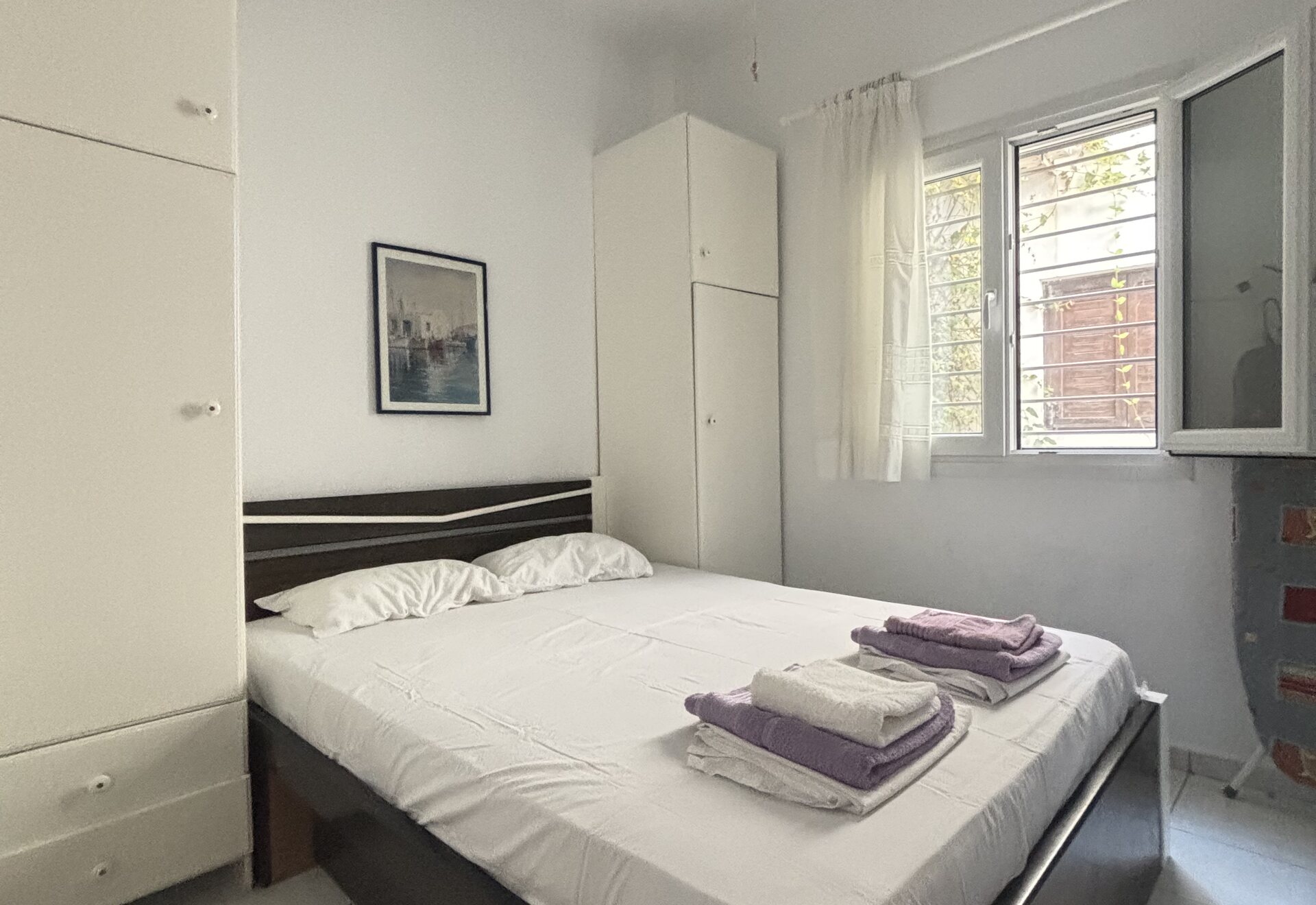 Polychrono Duplex bedroom with double bed, wardrobe, and window