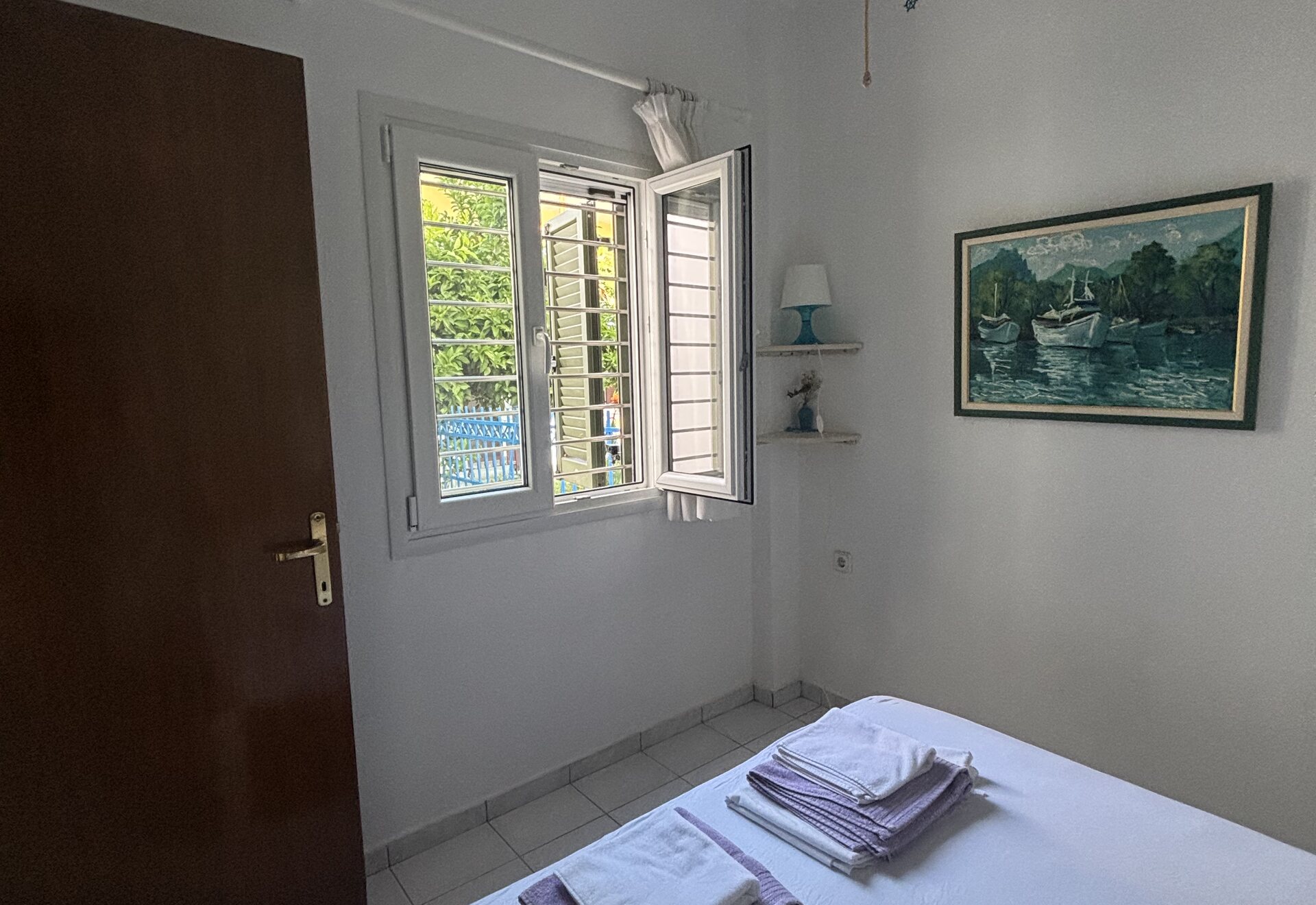Polychrono Duplex bedroom with double bed, window, and wall art