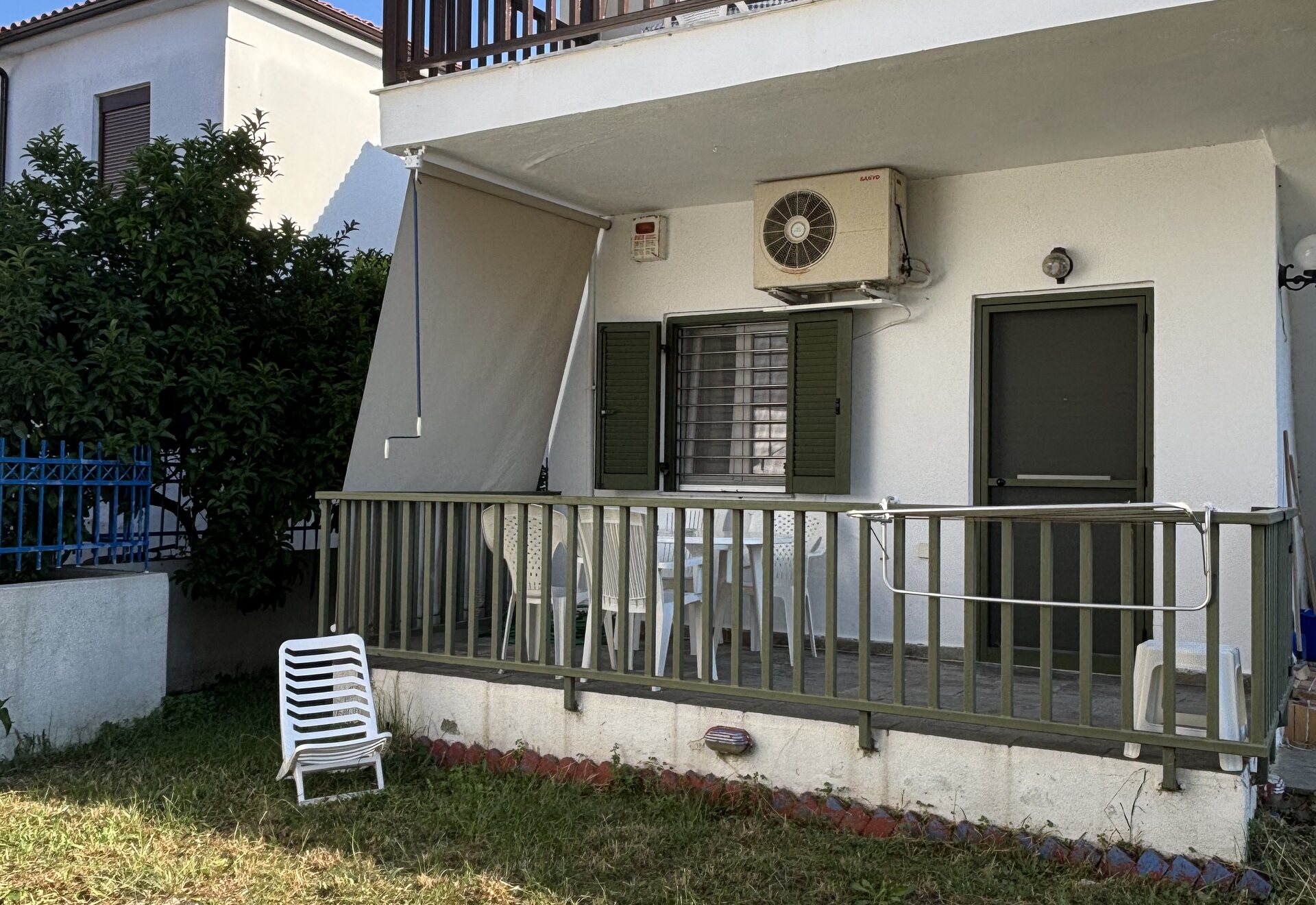 Polychrono Duplex building exterior with garden and terrace railing