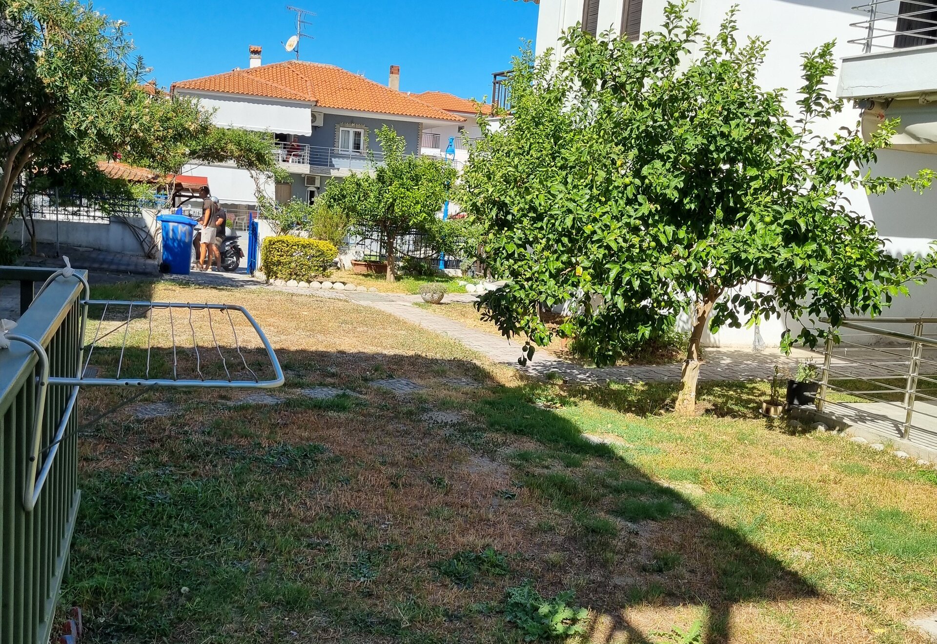 Polychrono Duplex garden and neighboring homes