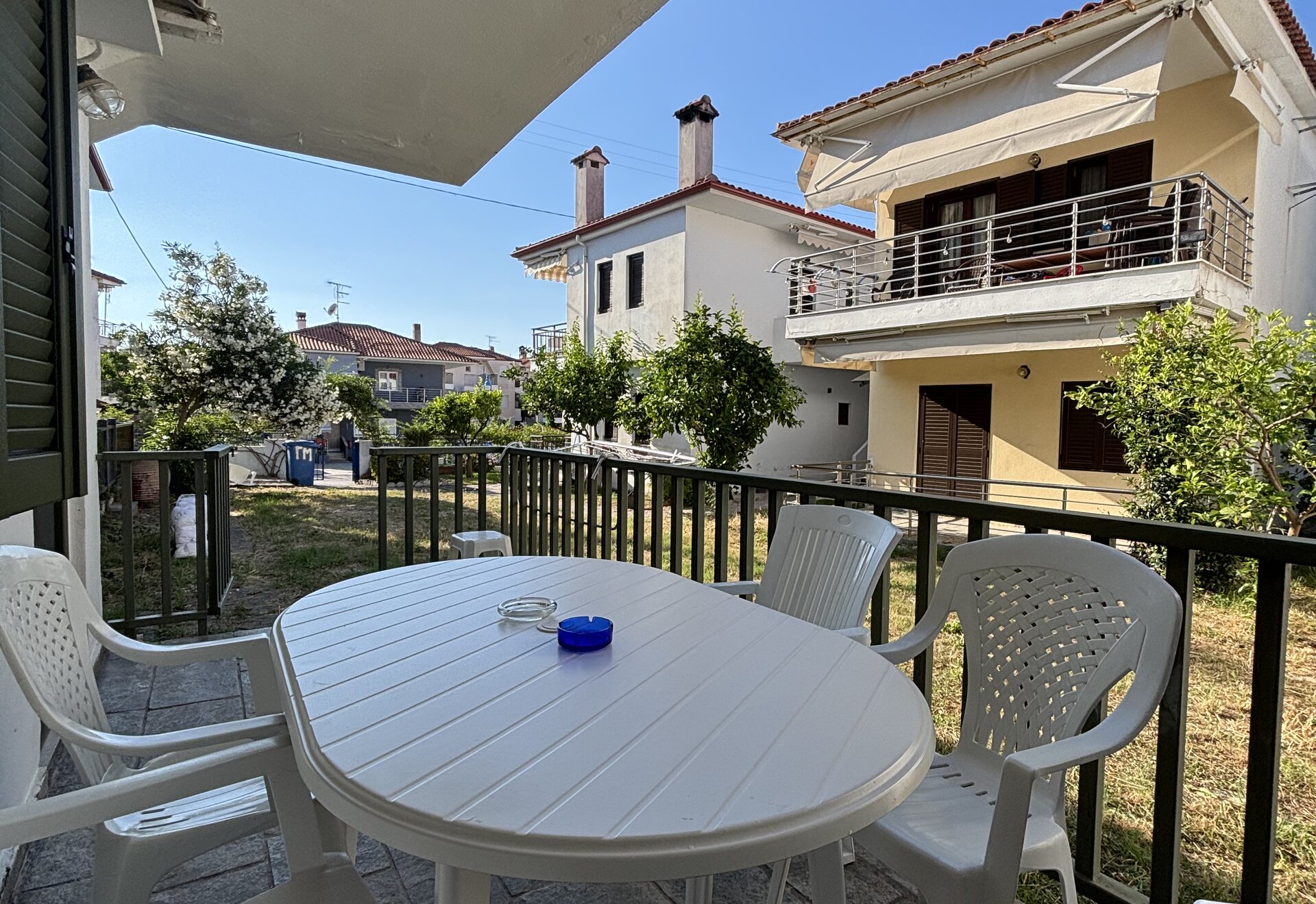 Polychrono Duplex wide terrace dining area with neighboring homes in view