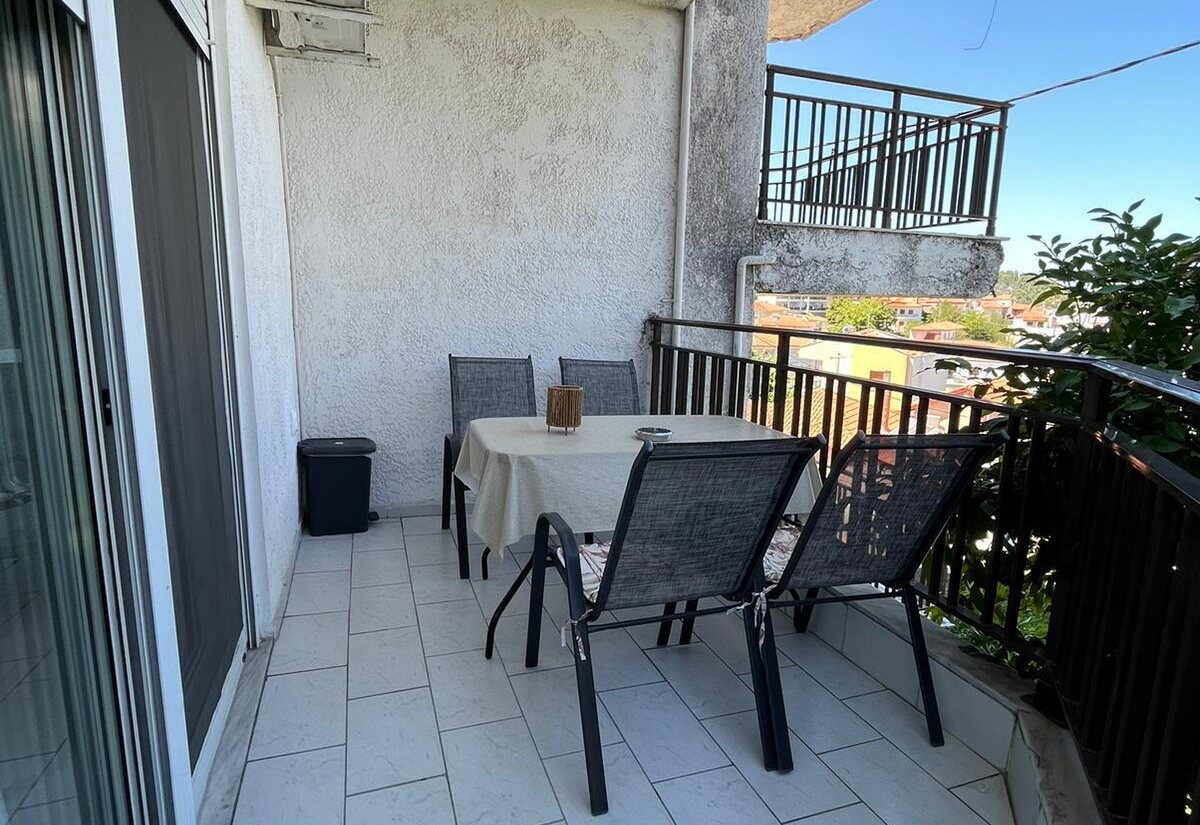 Aegean Dream balcony with outdoor dining table and chairs