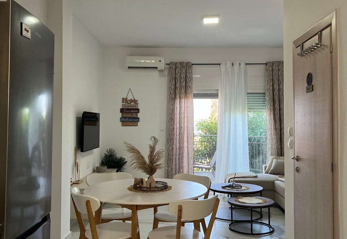 Aegean Dream dining area, living room, and balcony doors