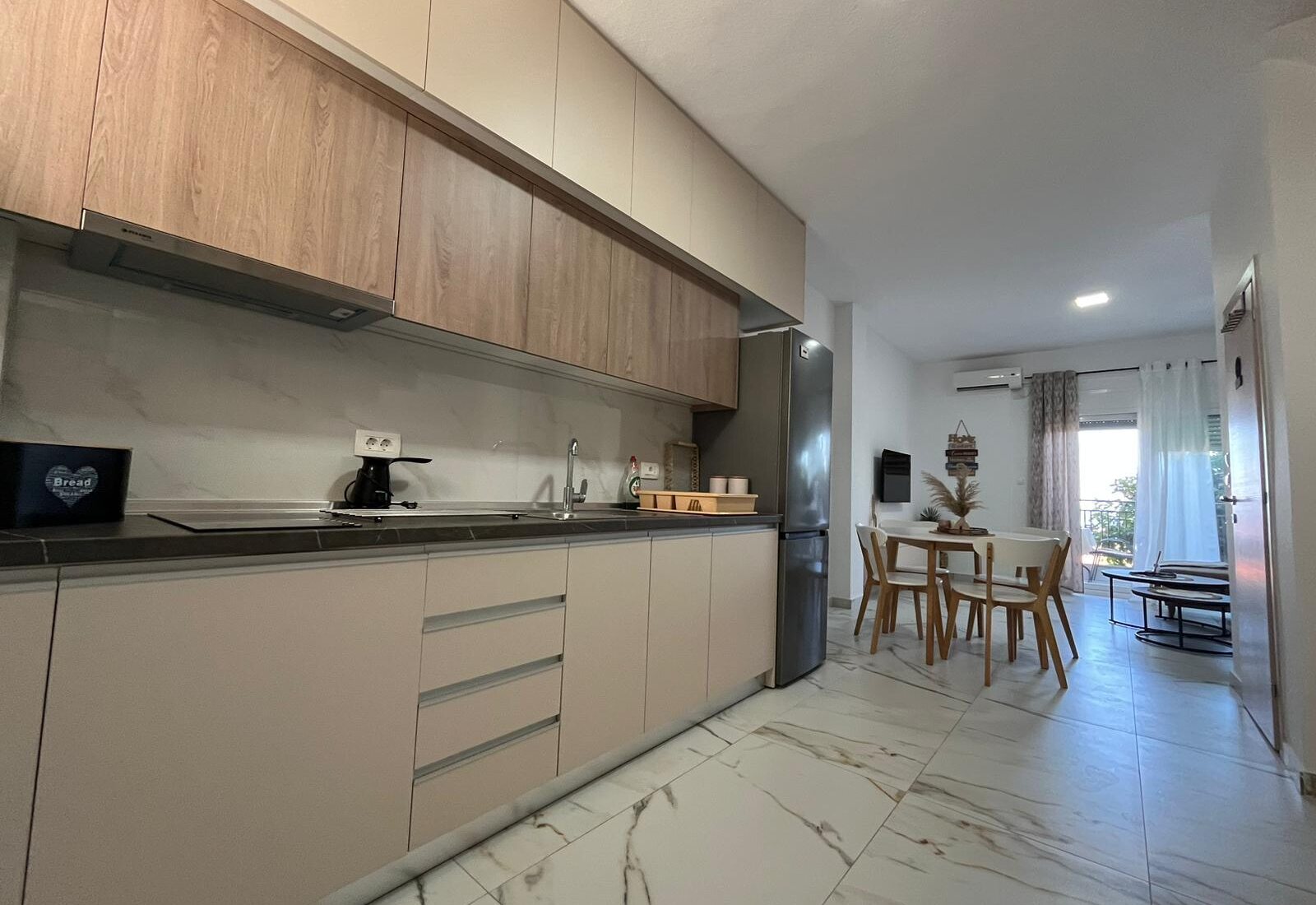 Aegean Dream kitchen with dining table and living room beyond