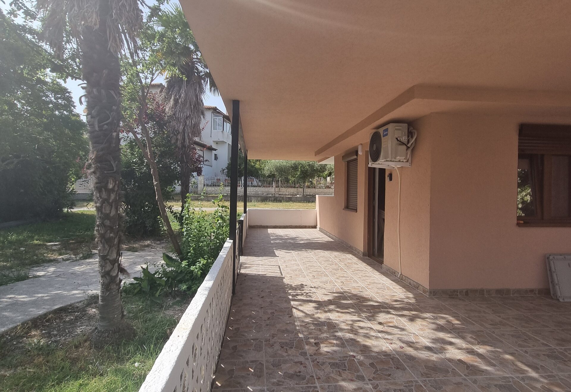 Garden Haven Apartment with Garden View side patio beside the building