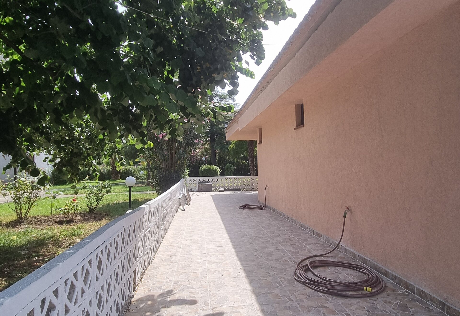 Garden Haven Apartment with Garden View tiled patio walkway beside the garden