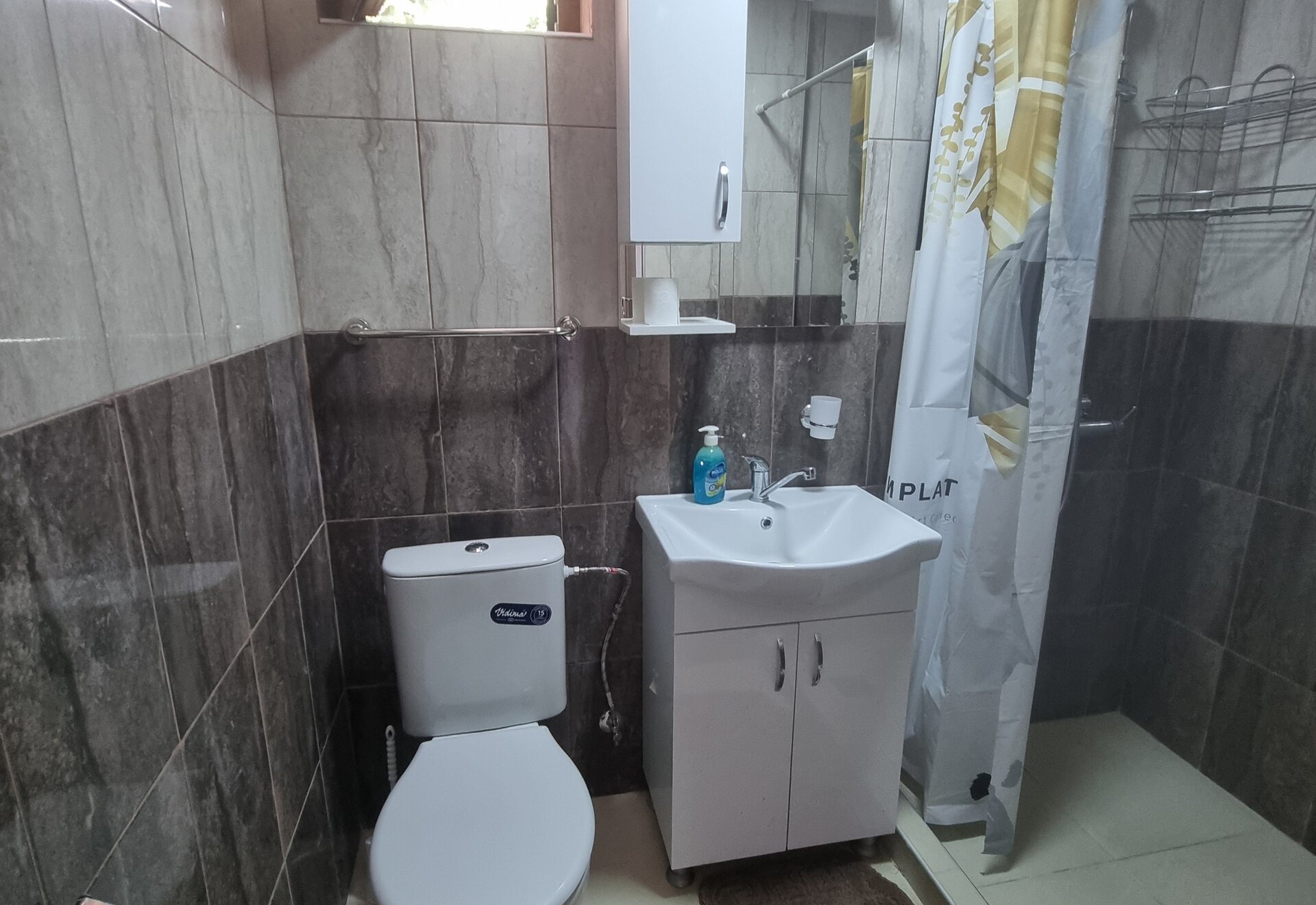 Garden Haven Two-Bedroom Apartment with Garden View bathroom with vanity and shower