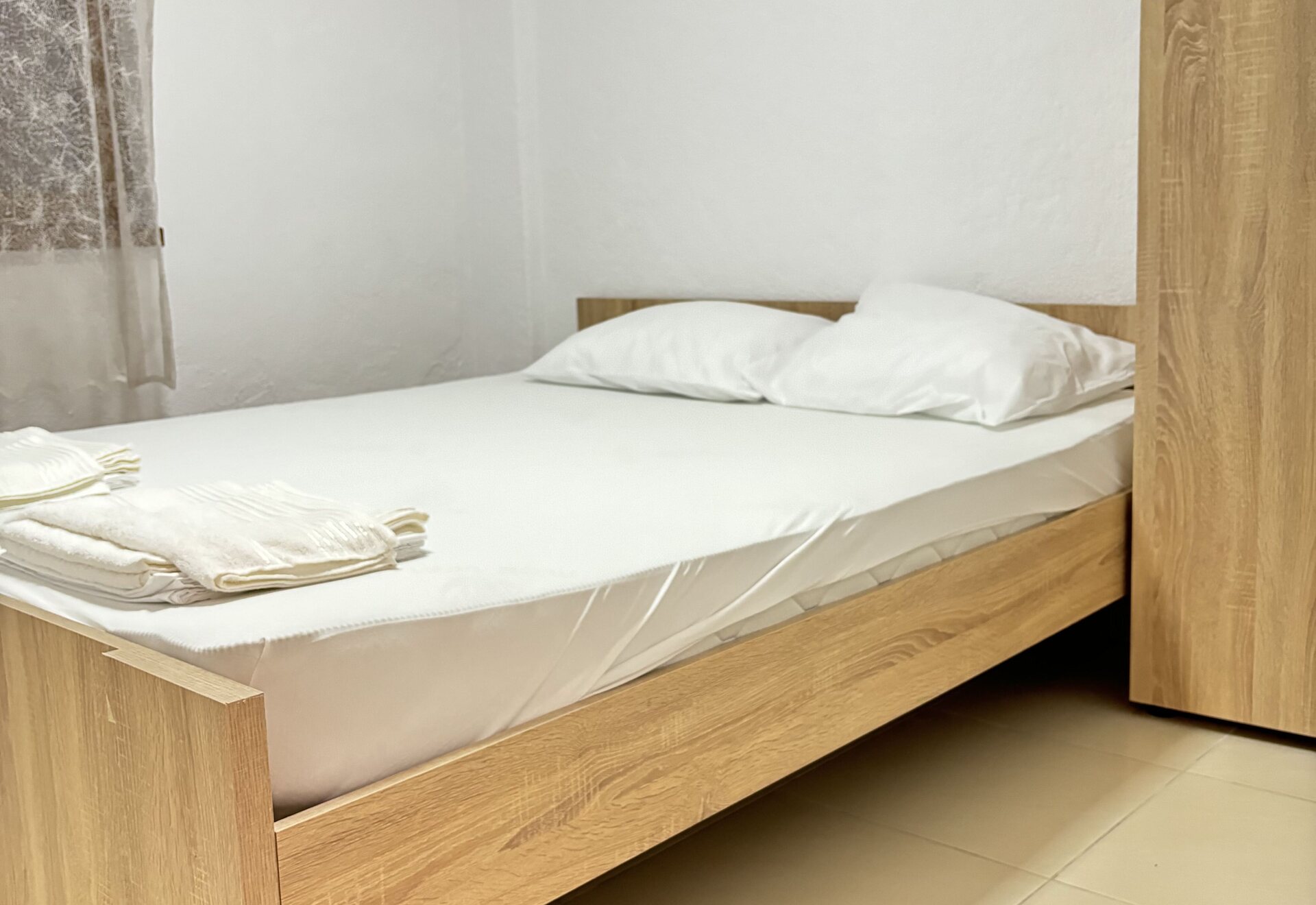 Garden Haven Two-Bedroom Apartment with Garden View double bedroom bed with wood frame