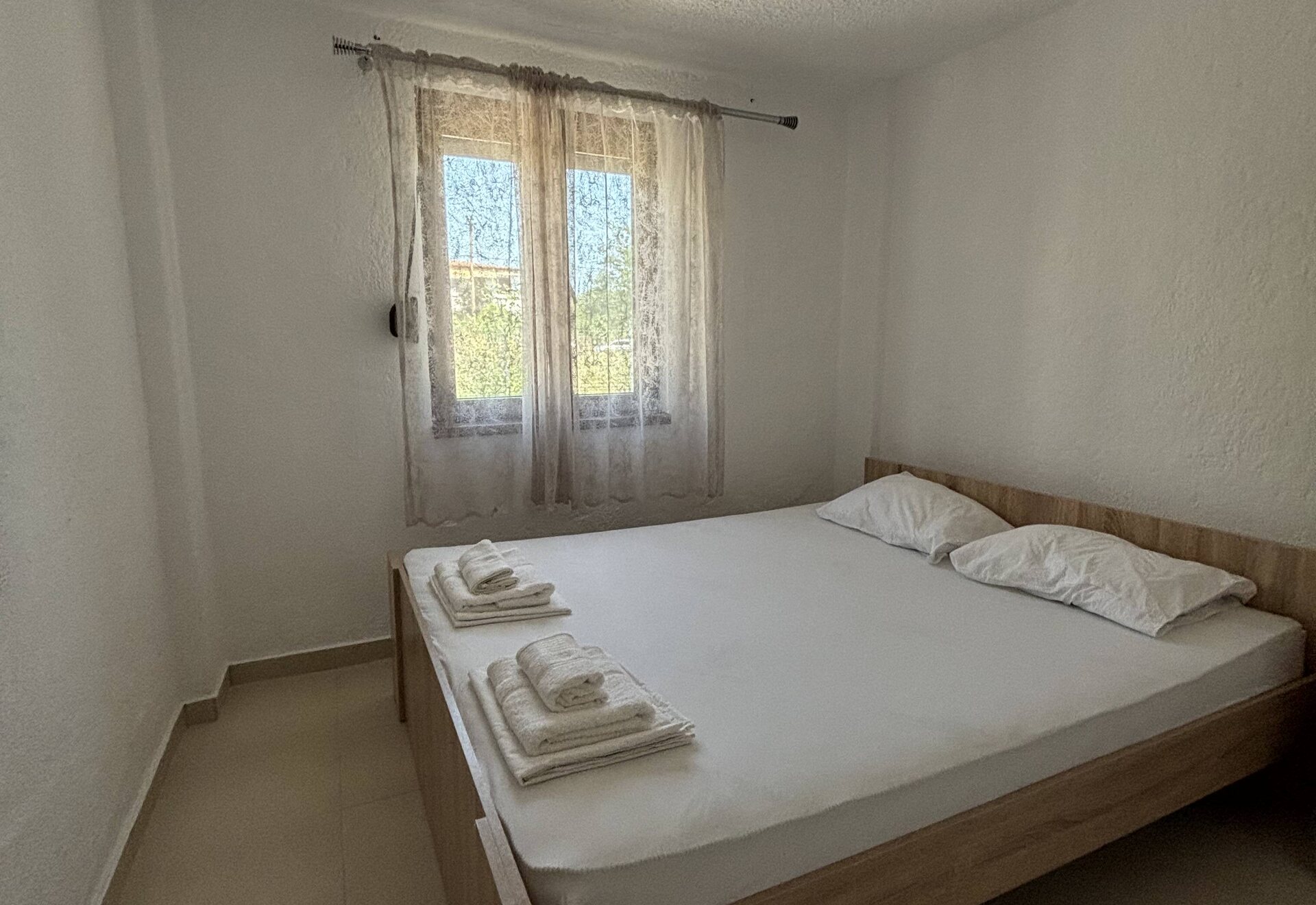 Garden Haven Two-Bedroom Apartment with Garden View double bedroom with garden-facing window