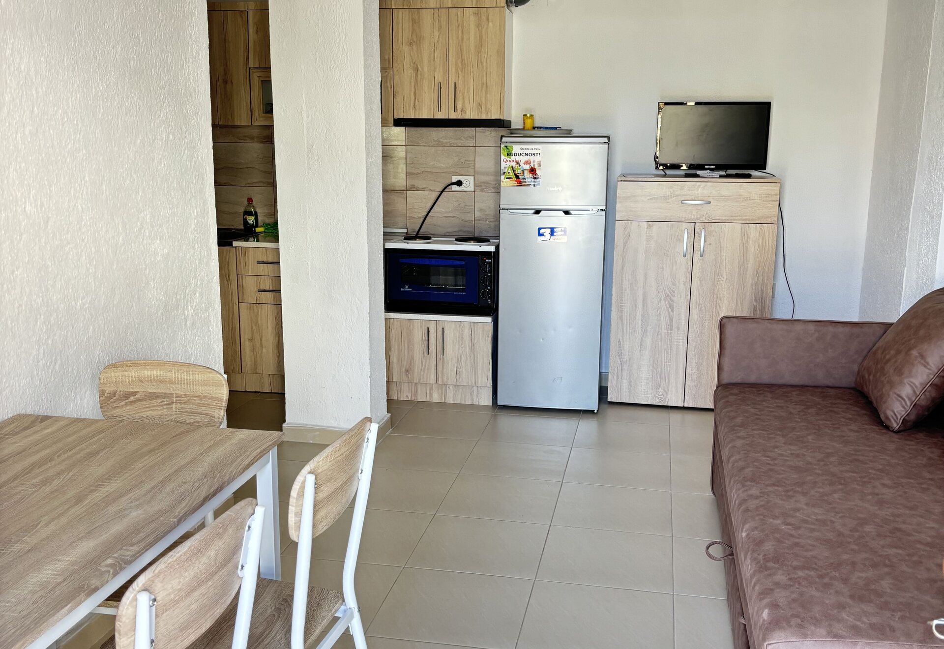 Garden Haven Two-Bedroom Apartment with Garden View kitchen, dining area, and living room sofa