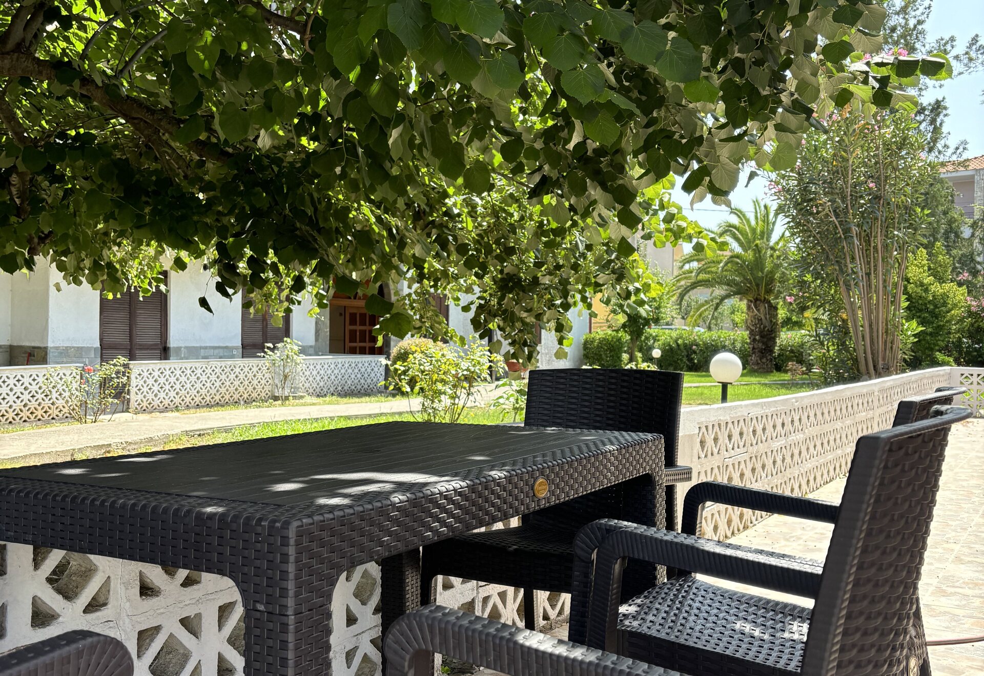 Garden Haven Two-Bedroom Apartment with Garden View shaded patio seating beside the garden