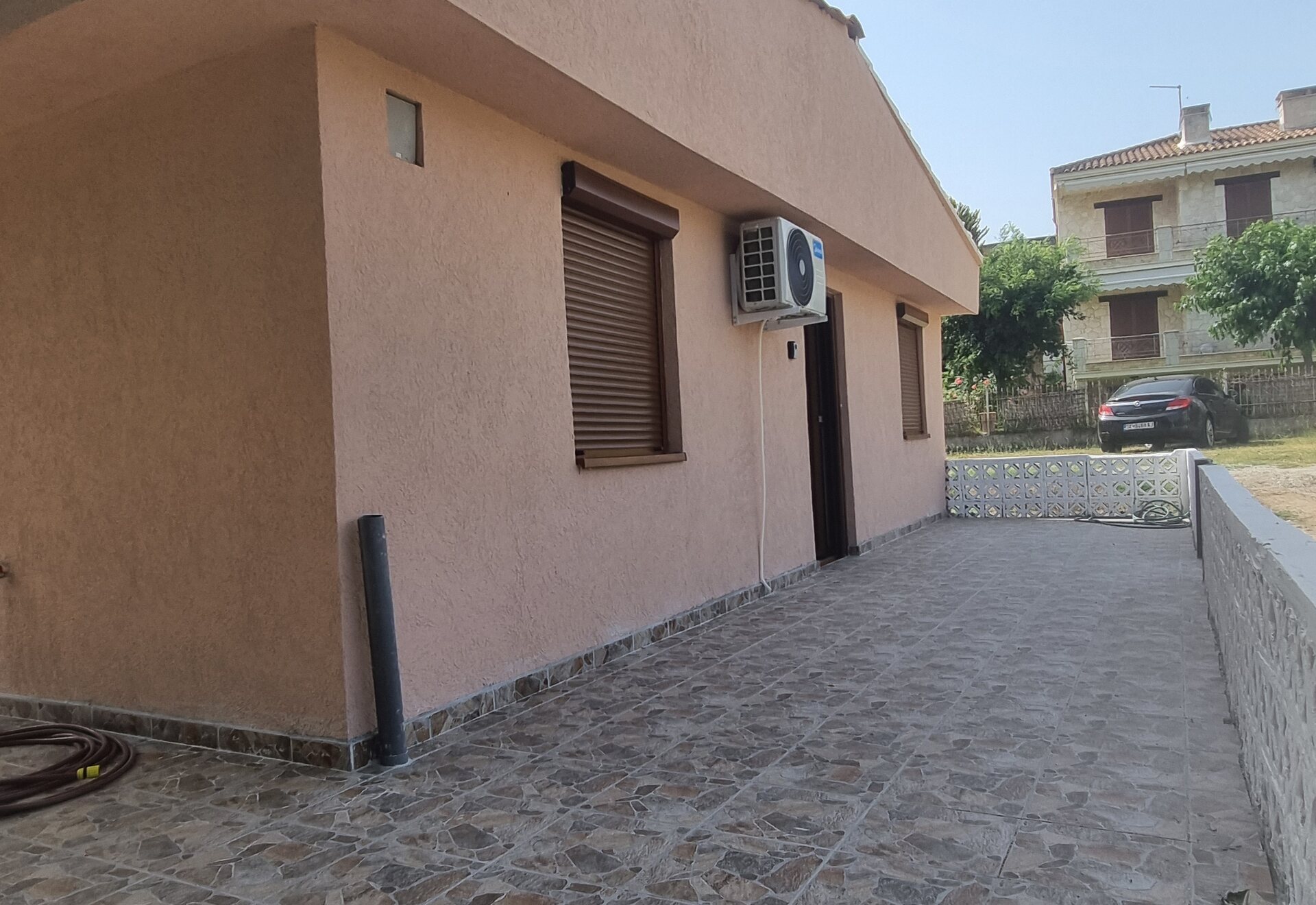 Garden Haven Two-Bedroom Apartment with Garden View side patio beside the building