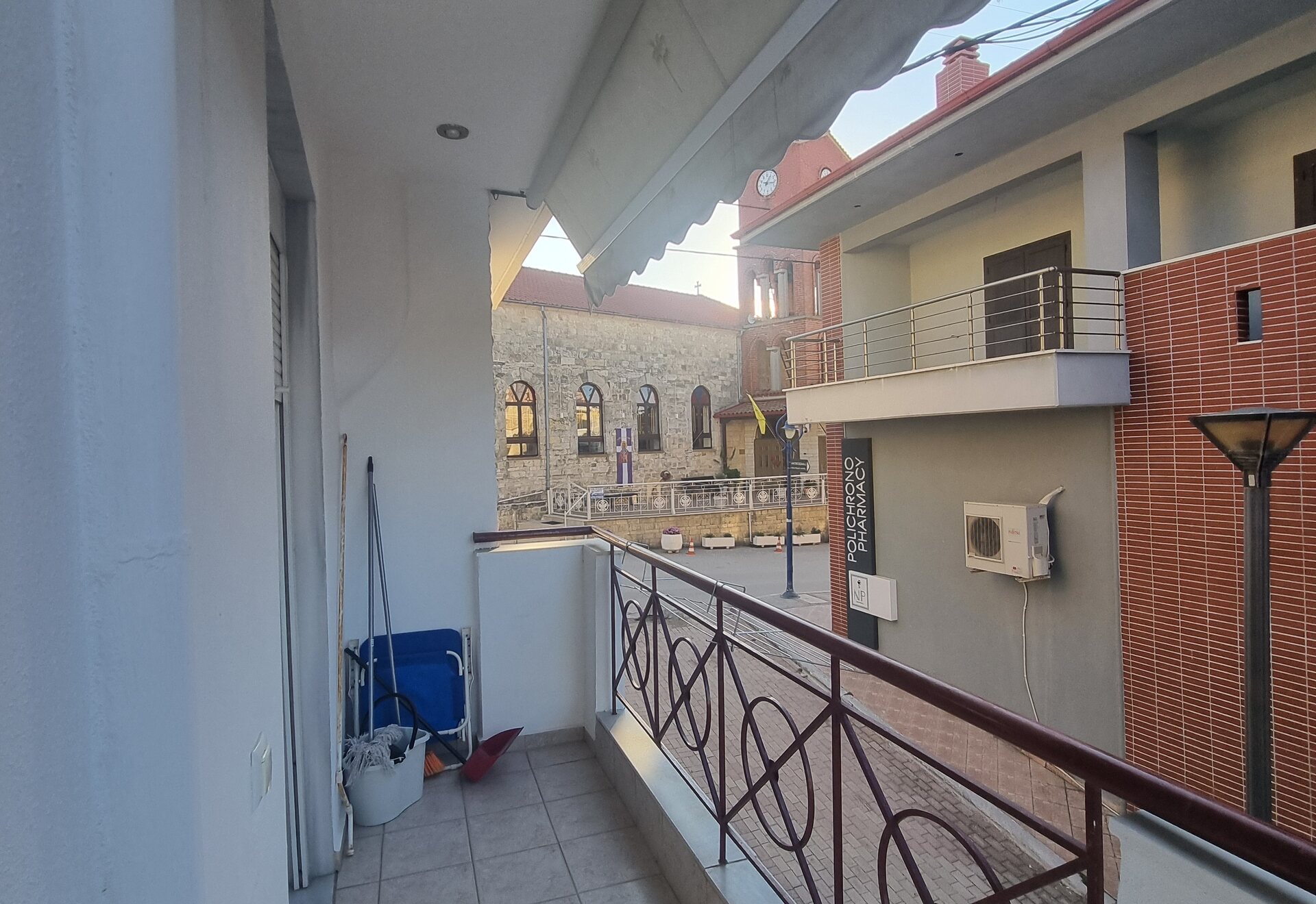 Polychrono Two Bedroom Apartment balcony outlook toward nearby buildings and church