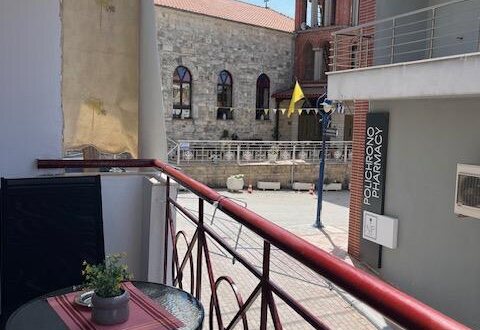 Polychrono Two Bedroom Apartment balcony seating with nearby church view