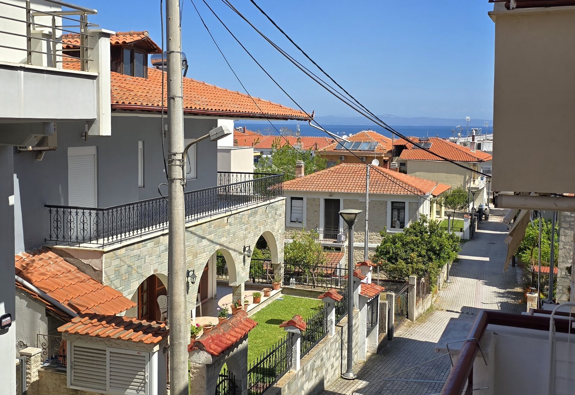 Polychrono Two Bedroom Apartment balcony view over the street toward the sea