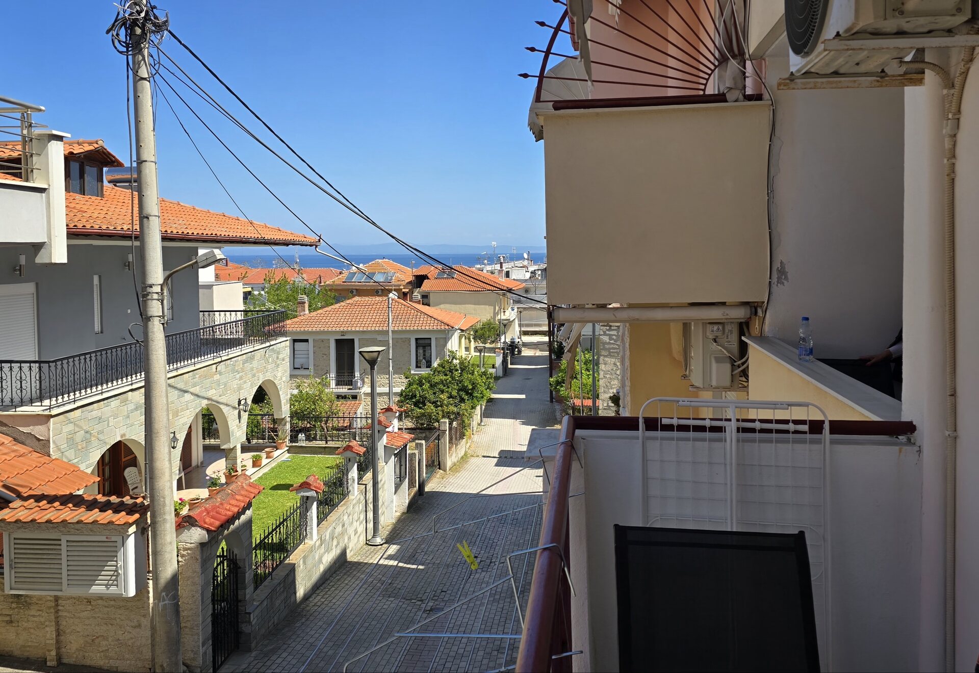 Polychrono Two Bedroom Apartment balcony with village rooftops and sea view