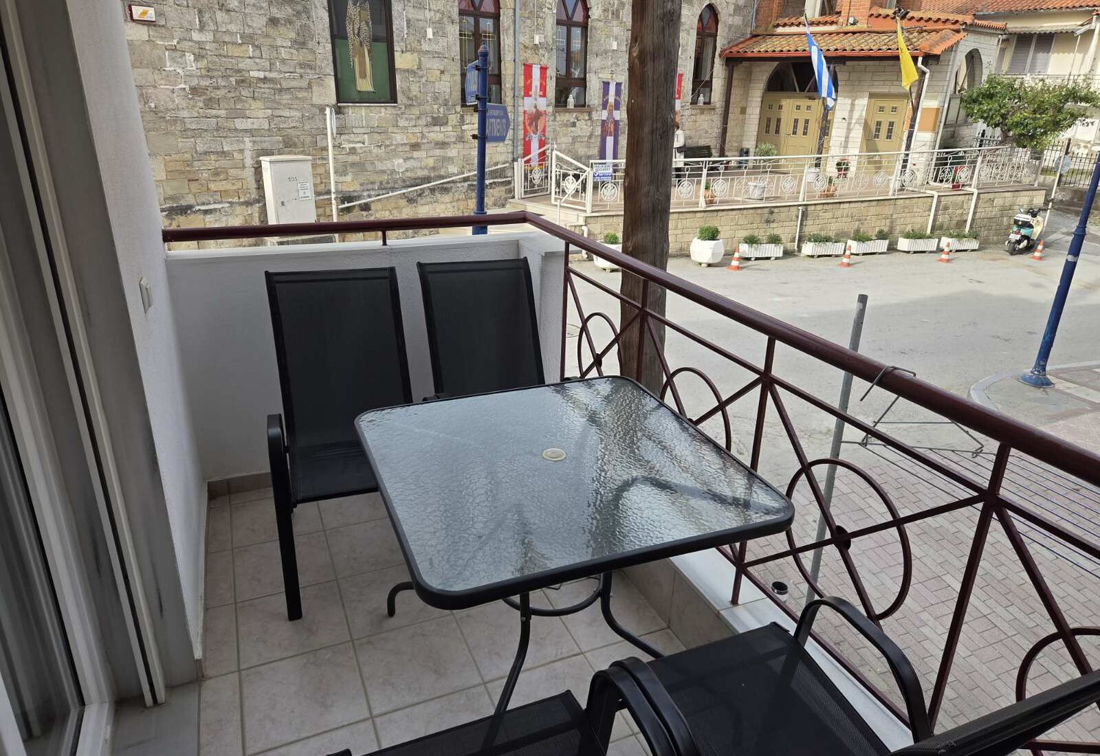 Polychrono Two Bedroom Apartment balcony table and chairs with street outlook