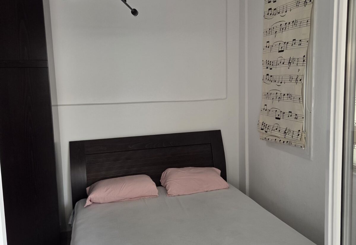 Polychrono Two Bedroom Apartment double bedroom with wall art
