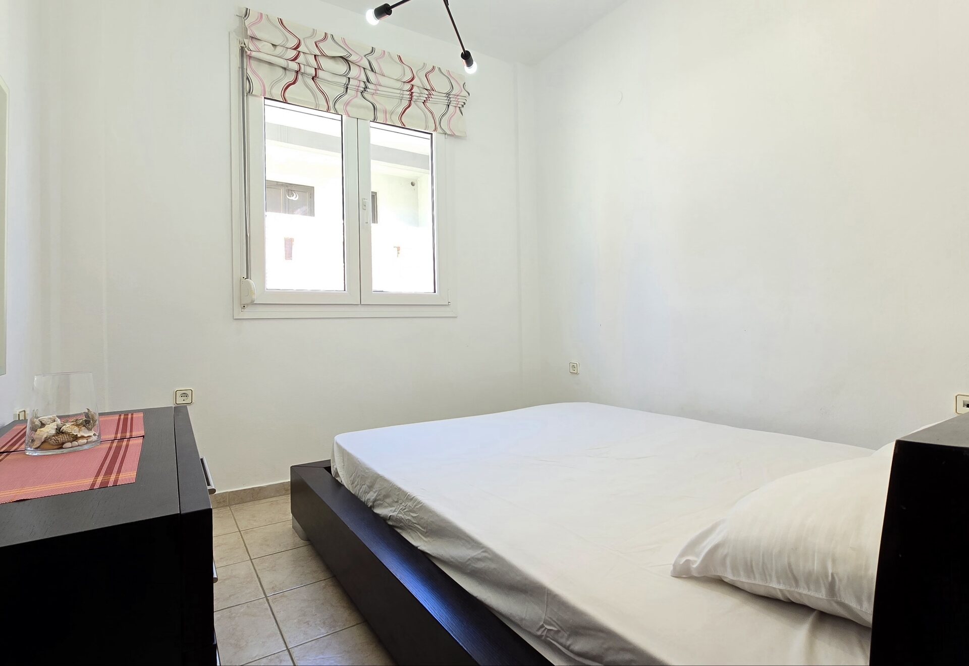 Polychrono Two Bedroom Apartment bedroom with double bed and window