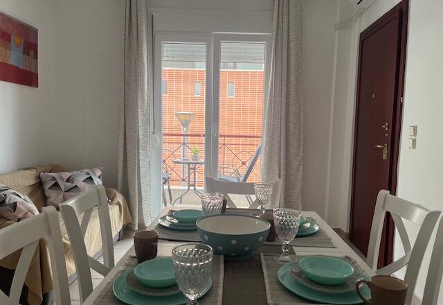 Polychrono Two Bedroom Apartment dining table set beside the living room and balcony