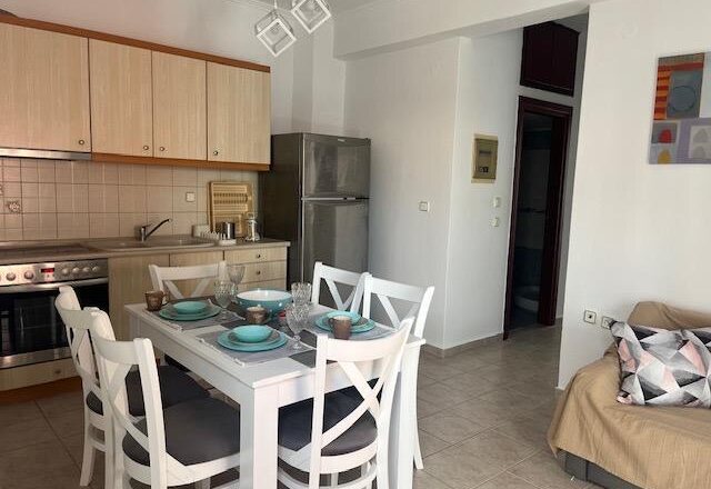 Polychrono Two Bedroom Apartment dining table beside the kitchen and sofa